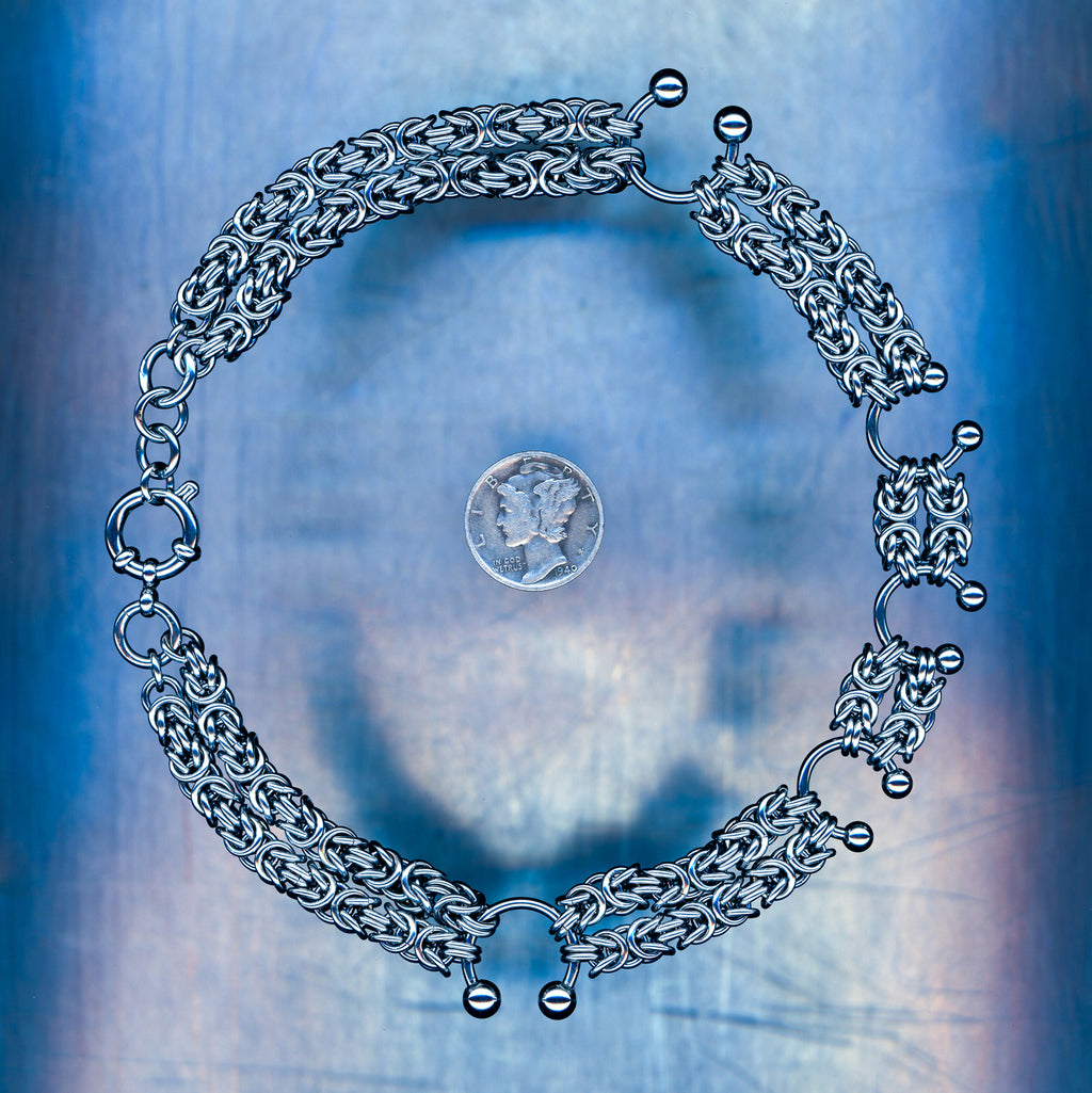 PRODUCT SHOT CLOSEUP SCAN OF DRIFTING WAVE NECKLACE 304 STAINLESS STEEL CHAIN MAILLE JEWELRY DOUBLED UP BYZANTINE WEAVE BULLRING HORSESHOE PIERCING ACCENTS